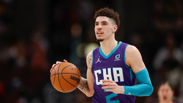 LaMelo Ball dribbles the ball.